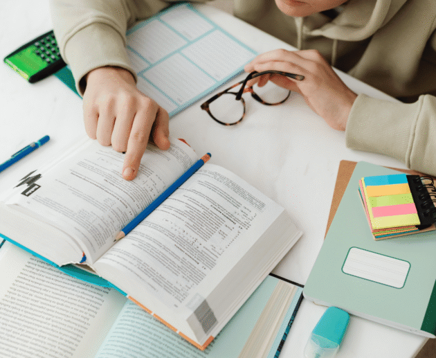 Young athlete studying a sports book at a desk